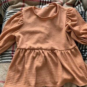 Lush apricot colored shirt looks great with jeans